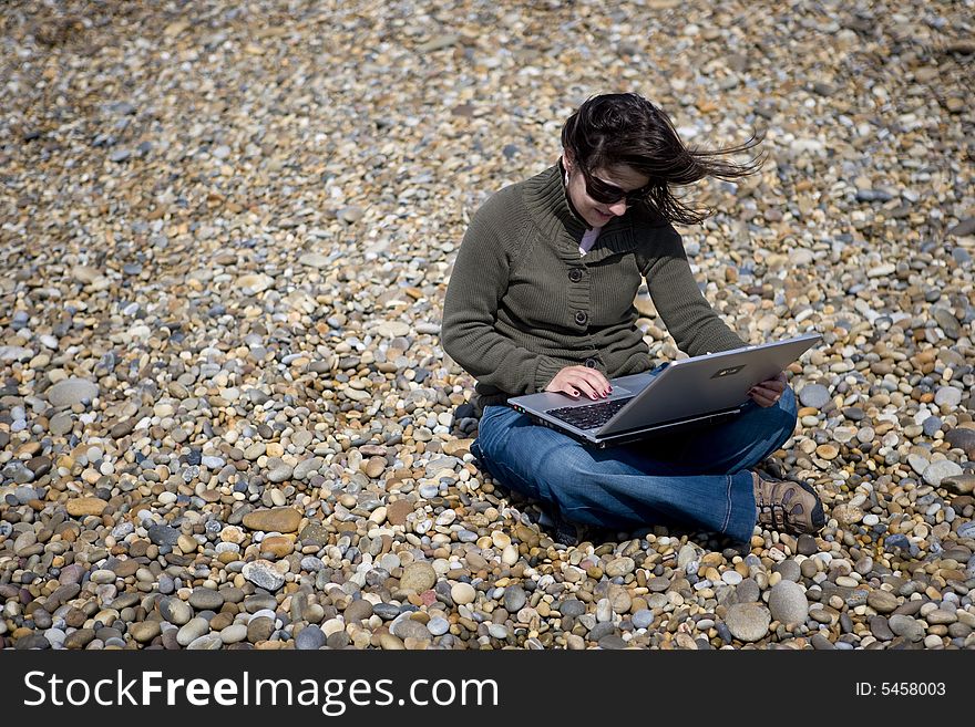 Young woman with laptop computer in beach