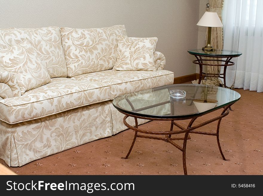 Sofa and glass table in the suite