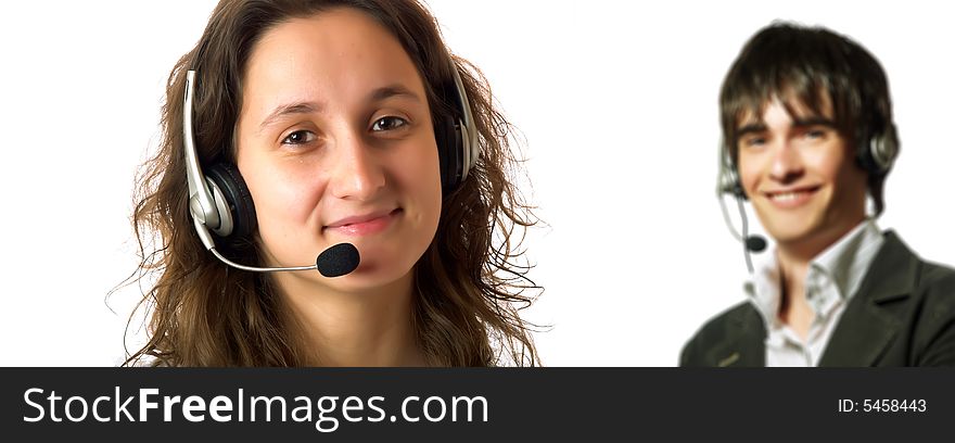 A young pretty customer service representative lady and one of her colleagues are smiling. They have headphones and they are wearing elegant shirts. A young pretty customer service representative lady and one of her colleagues are smiling. They have headphones and they are wearing elegant shirts.