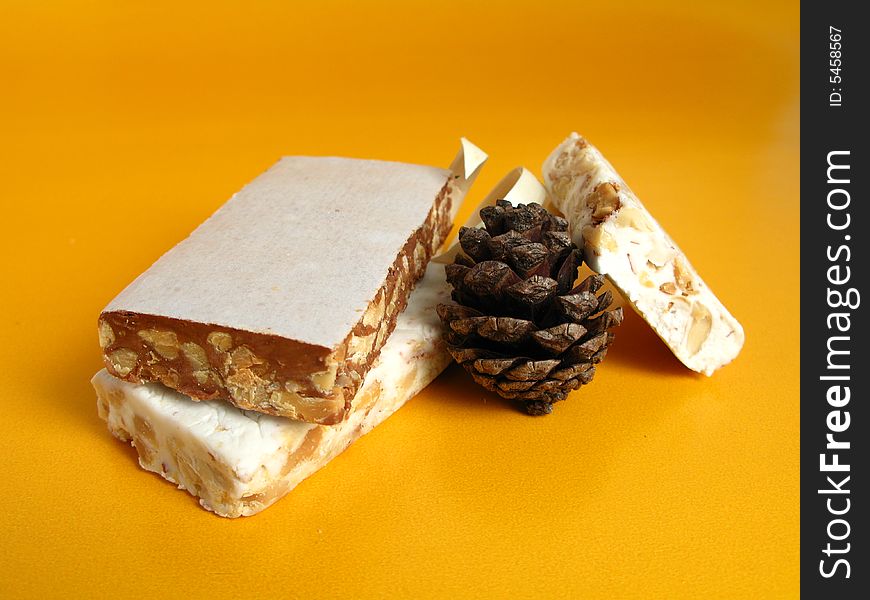 Nougat with a pine cone on a yellow background