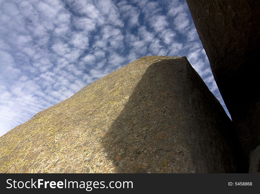 A boulder in the Wichita National Wildlife Refuge in Oklahoma framing the sky and clouds. A boulder in the Wichita National Wildlife Refuge in Oklahoma framing the sky and clouds.