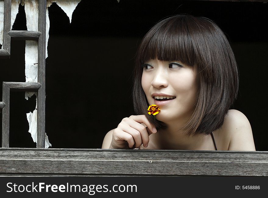 Ancient window and girl.. Here is one of the ancient villages of China. Ancient window and girl.. Here is one of the ancient villages of China.