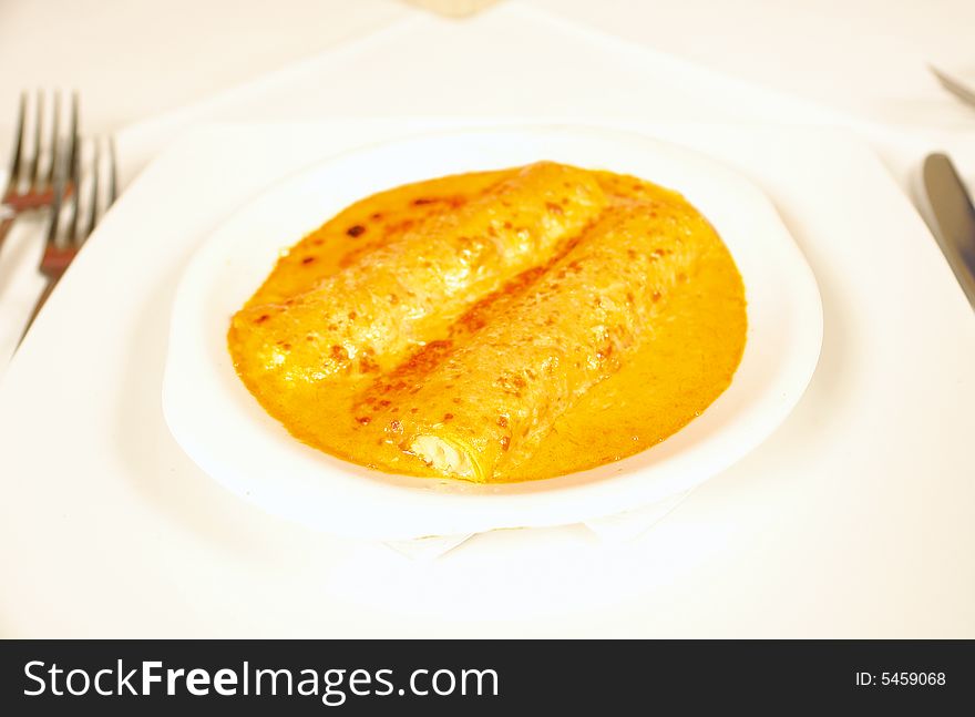 Filled canellonis with cheese and tomato sauce
