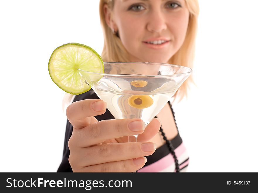 Girl reaching to you glass with martini cocktail. Focus on the glass with blured girl face