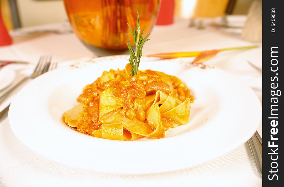 Parpadelle pasta with chicken or rabbit meat and tomato sauce. Parpadelle pasta with chicken or rabbit meat and tomato sauce