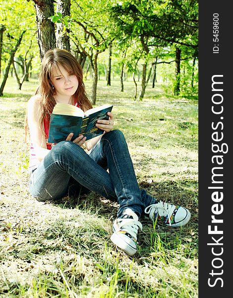 Beautiful girl read the book and lying on Grass. Beautiful girl read the book and lying on Grass