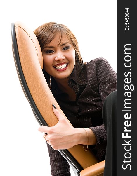 Cheerful young japanese girl sitting in armchair.