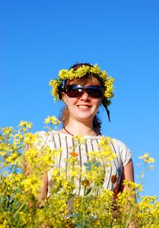 Beautiful Girl And Yellow Flowers Over A Blue Sky Royalty Free Stock Images