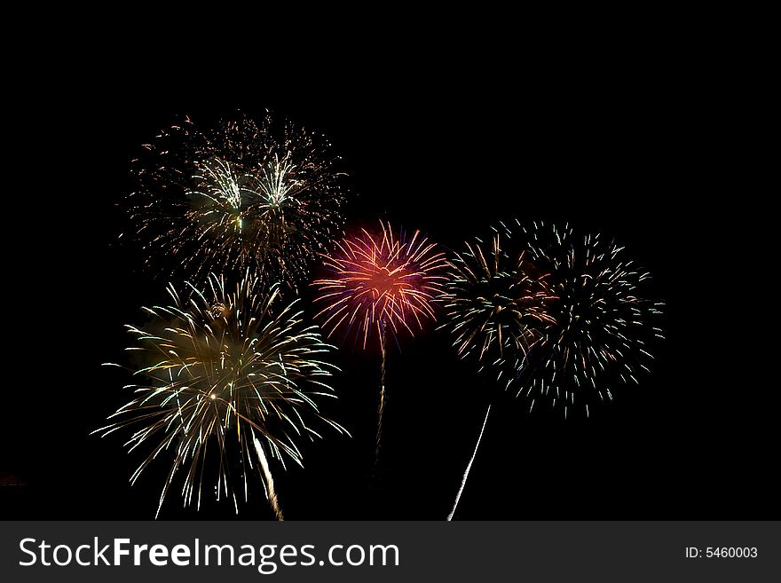 Fireworks display with several different colored fireworks exploding in the sky. Fireworks display with several different colored fireworks exploding in the sky.