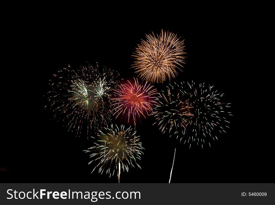 Fireworks display with several different colored fireworks exploding in the sky. Fireworks display with several different colored fireworks exploding in the sky.
