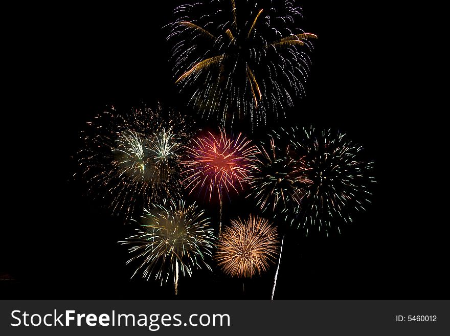 Fireworks display with several different colors exploding in the sky. Fireworks display with several different colors exploding in the sky.