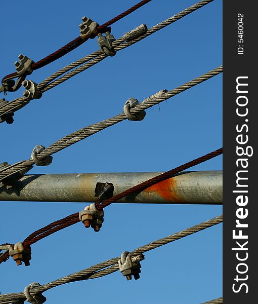 A cable fence in front of a blue sky