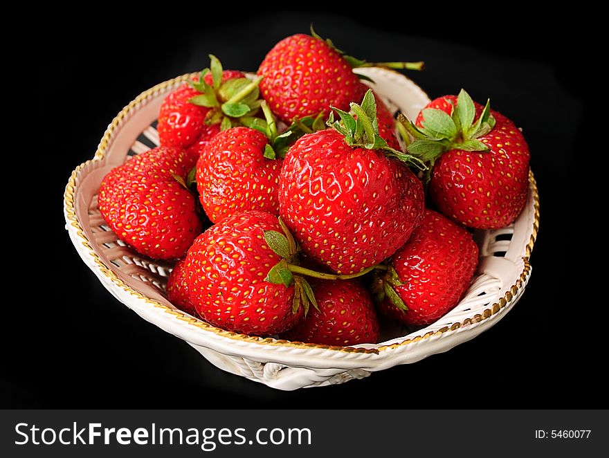 Macro of strawberries against black