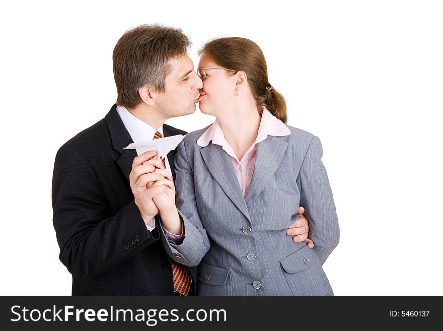 Business man and woman kissing with paper airplane in hands. Business man and woman kissing with paper airplane in hands