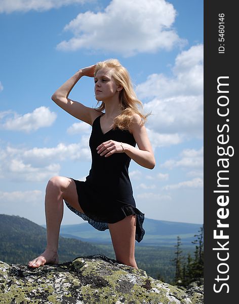 Woman In The Black Dress On Rock