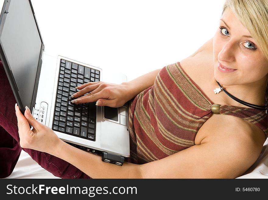 Young beautiful girl working with laptop. Isolated