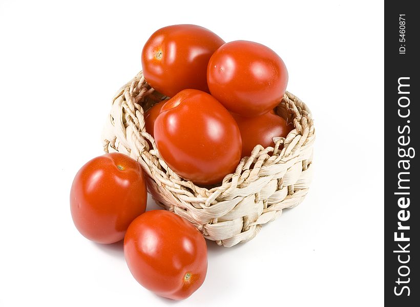 Fresh tomatoes in basket isolated on a white background. Fresh tomatoes in basket isolated on a white background.