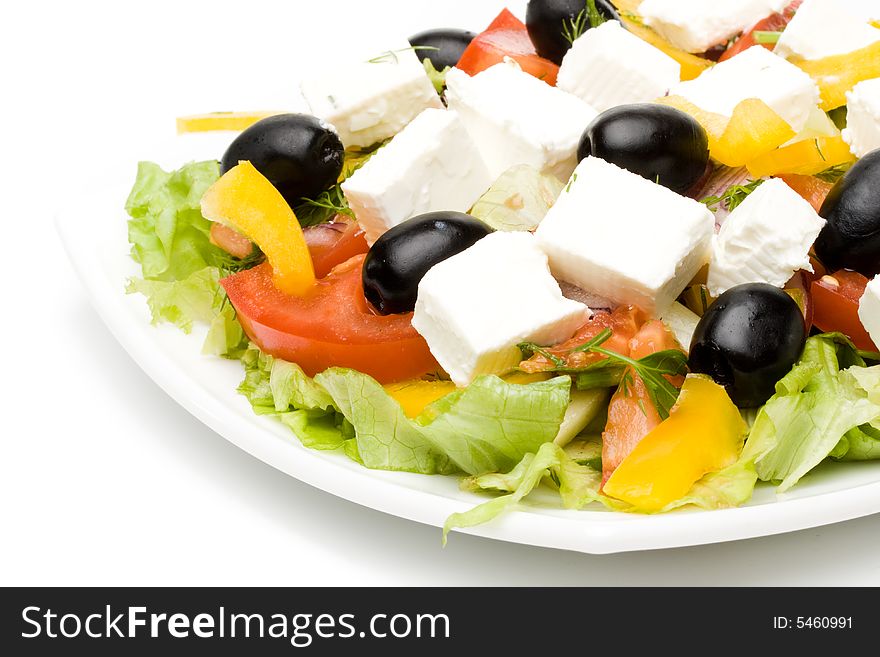 Appetizing greeak salad on a plate. Close up. Appetizing greeak salad on a plate. Close up.