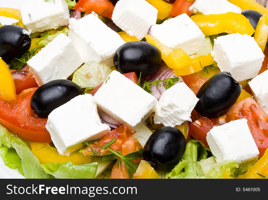 Appetizing greeak salad on a plate. Close up. Appetizing greeak salad on a plate. Close up.