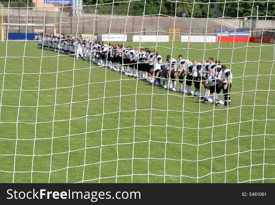 Net with american football players 
focus on net