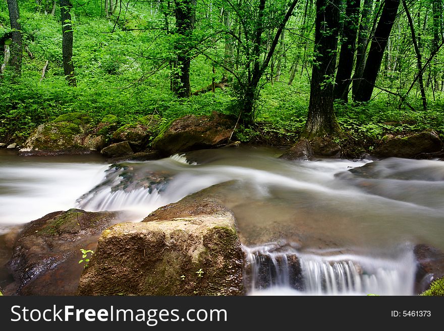 An image of a waterfall in spring forest