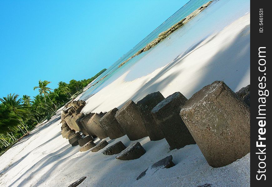 Stone barriers installed at the beach to stop the waves, A man's invasion in nature. Stone barriers installed at the beach to stop the waves, A man's invasion in nature