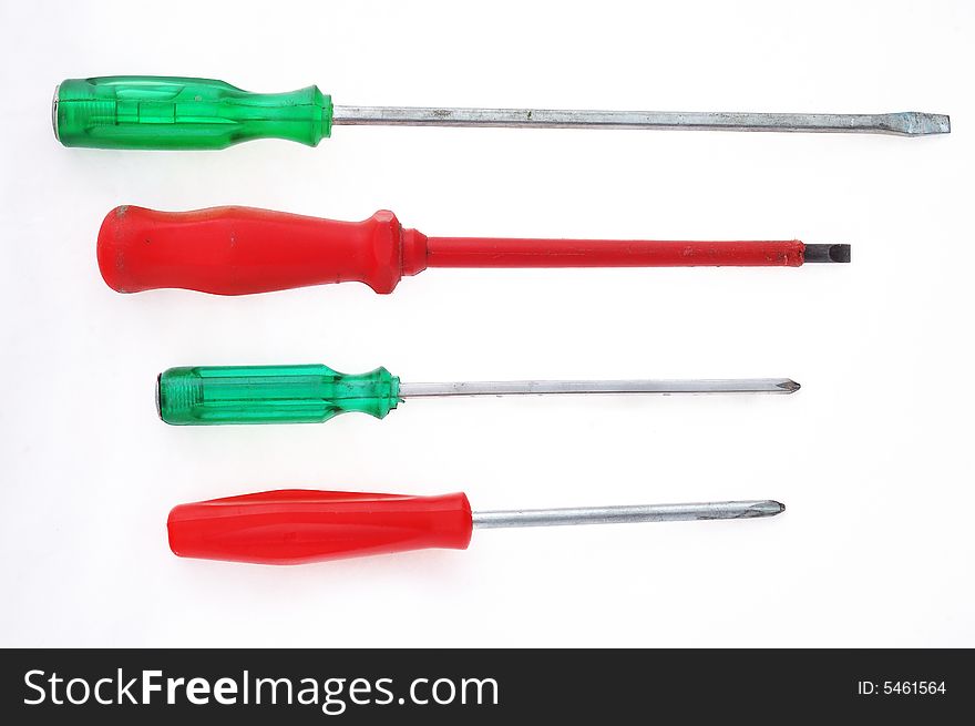 Red and green screw-drivers on the white background. Red and green screw-drivers on the white background.