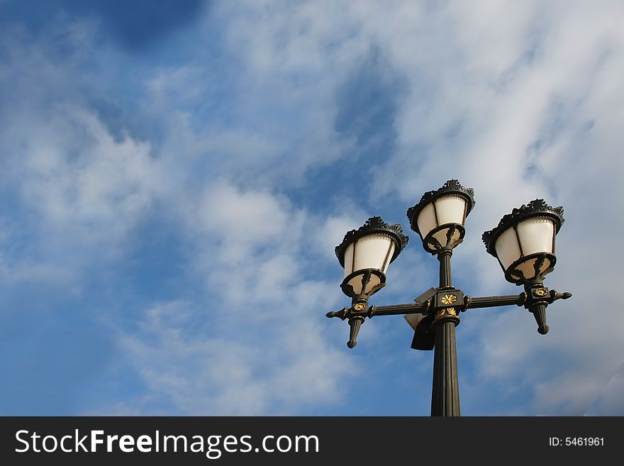 Old lamp against blue sky