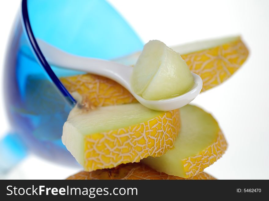Close up to cantaloupe on spoon with slices  in ice cream cup