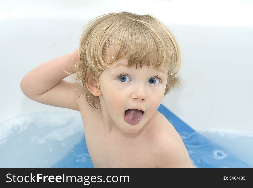 Cheerful boy on white background. In bath.