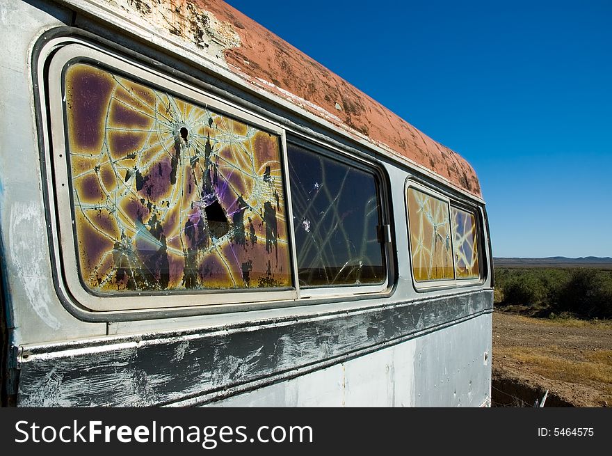 Abandoned bus in the patagonian steppe with broken windows.