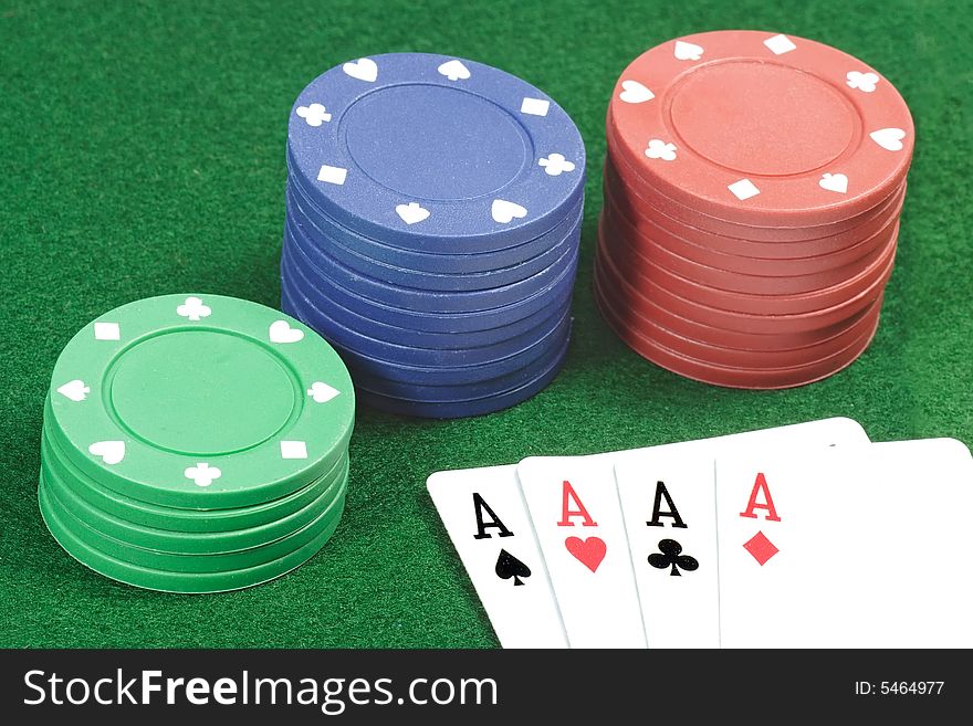 Playing cards and poker jetons on green background. Playing cards and poker jetons on green background