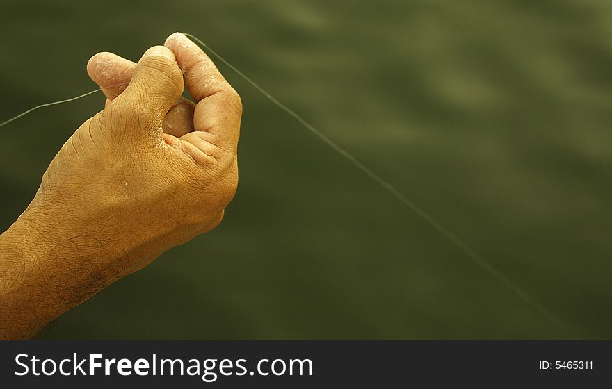 A fisherman prepares to catch fish at a river in Dubai, UAE. A fisherman prepares to catch fish at a river in Dubai, UAE