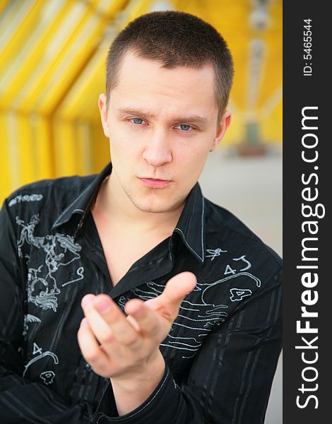 Serious young man on footbridge