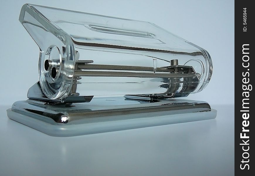A glassy hole puncher on the table