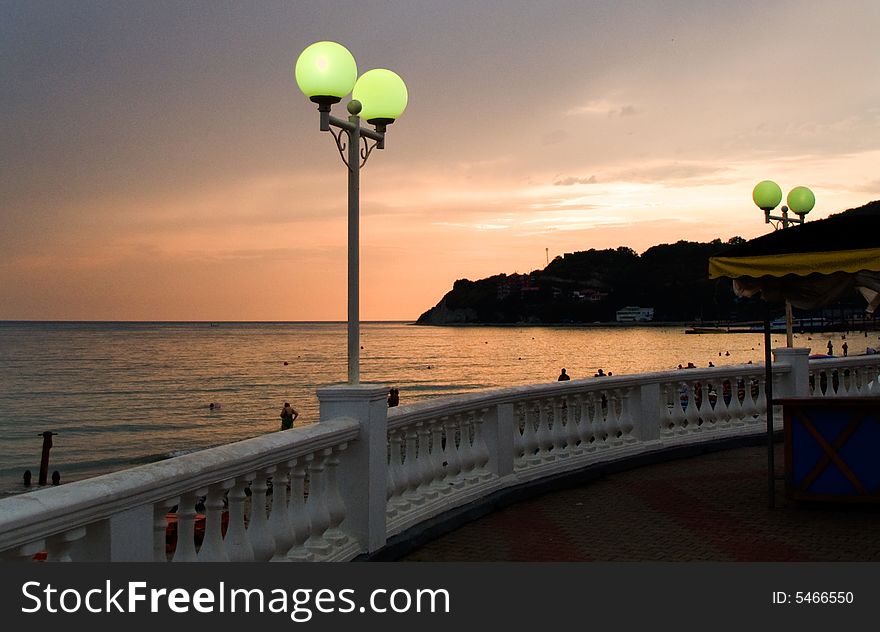 Lamp on the sea-front in the summer evening