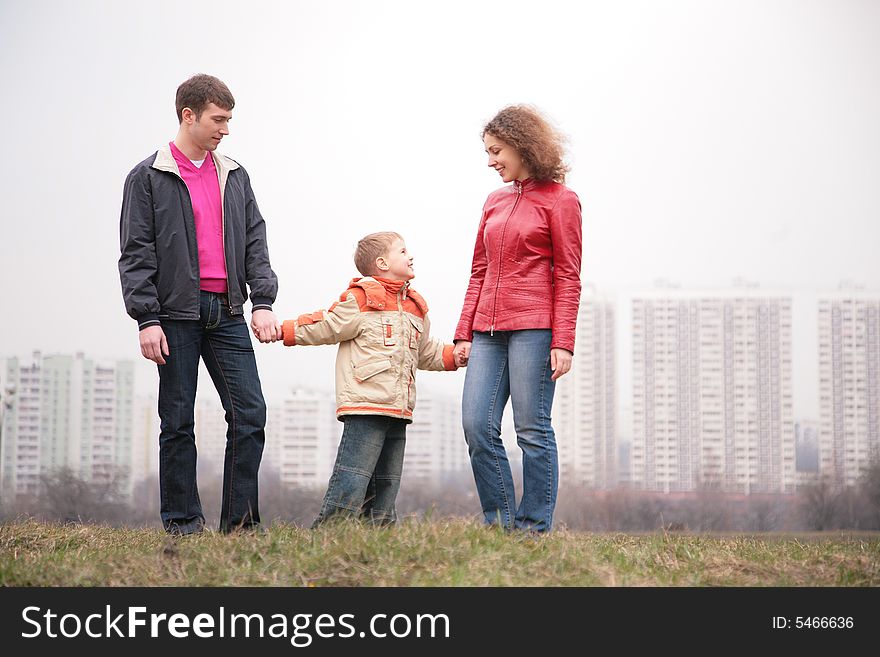 Family stand outdoor in city on spring