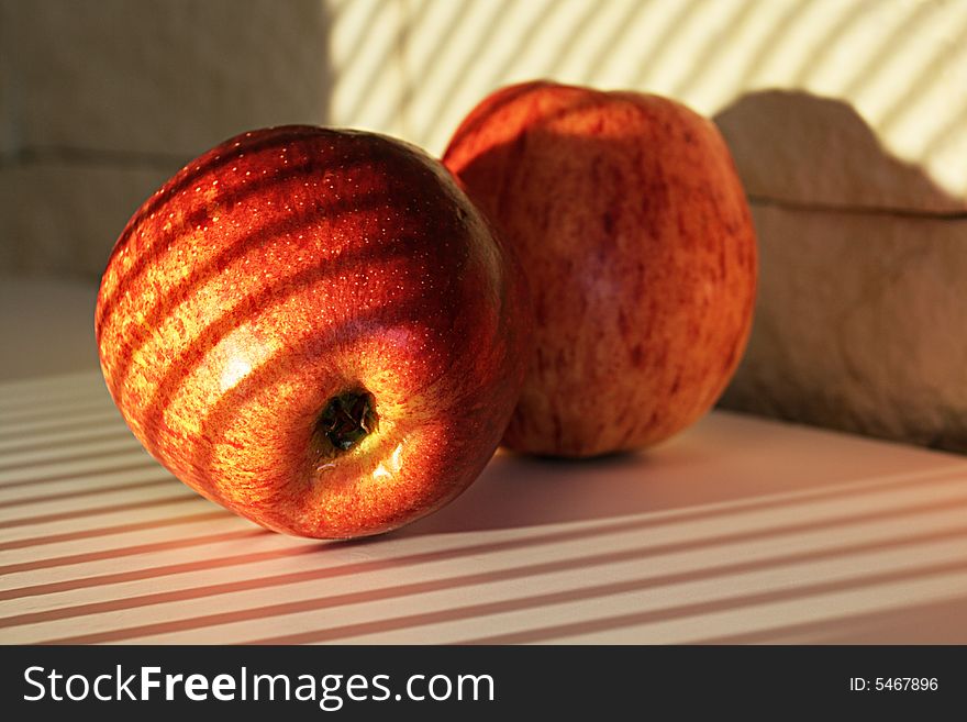 Apples in sunlight on a white table
