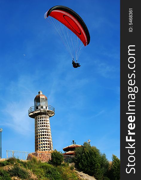 Beacon and the parachuter on a background of the blue sky