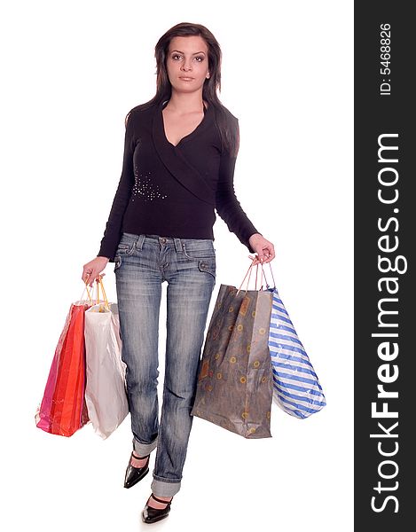 Young brunette girl holding bags and gifts after shopping. Young brunette girl holding bags and gifts after shopping