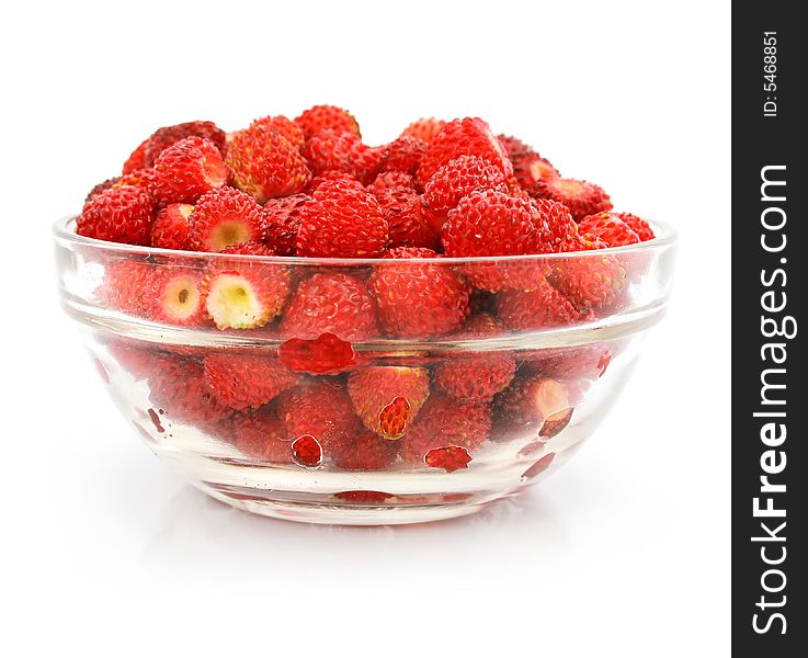 Red strawberry fruits in glass vase isolated on white background