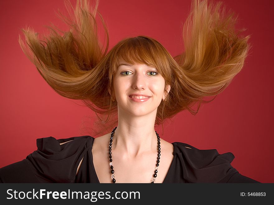 Beautiful red-haired girl shaking her hair