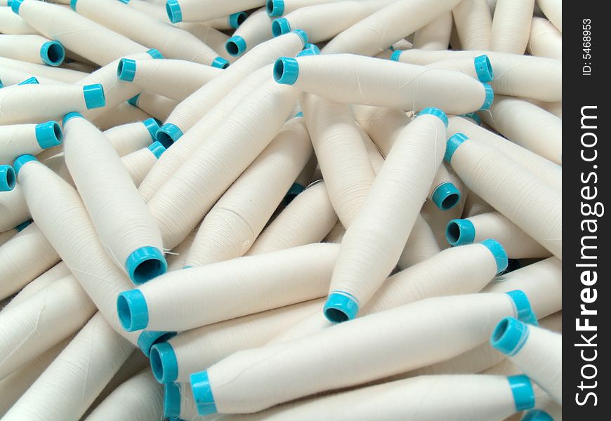 White cotton yarn spools (bobbins) in a textile factory