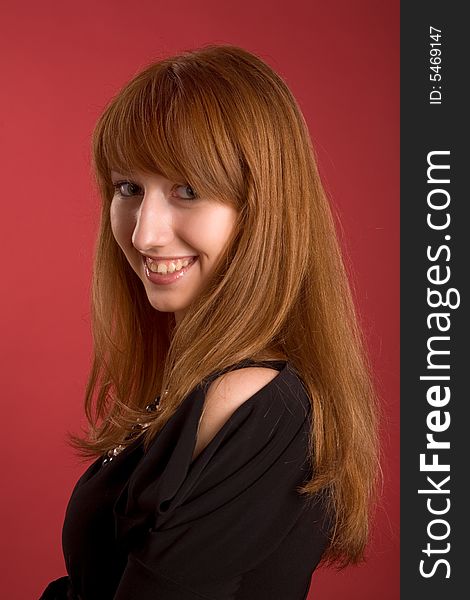 Beautiful smiling girl isolated on red background