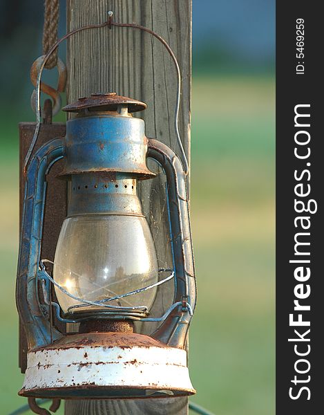 Antique kerosene lantern hanging on a barn post in rural Virginia.