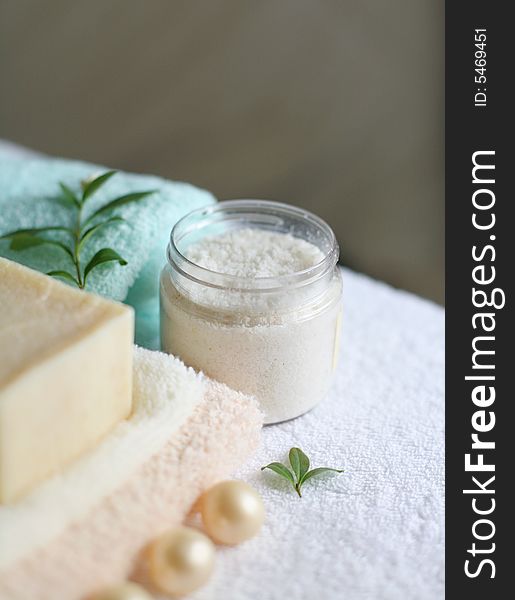 Conceptual photo with beauty items, soap, towels, peeling and white flower. Conceptual photo with beauty items, soap, towels, peeling and white flower