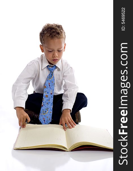 Young boy dressed as businessman writes in his notebook - isolated on white. Young boy dressed as businessman writes in his notebook - isolated on white