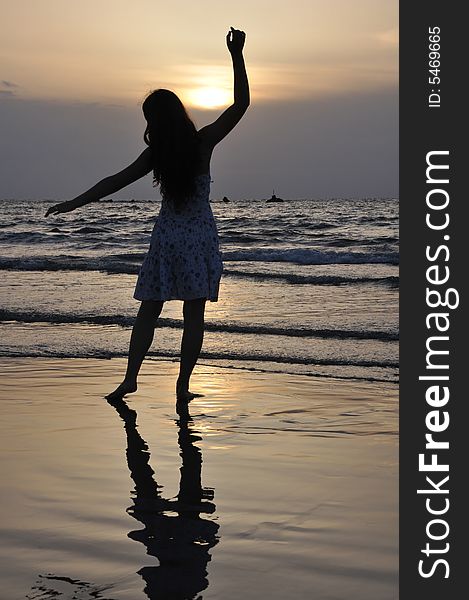 Silhouette of a teenager girl standing on background of a sea. Silhouette of a teenager girl standing on background of a sea