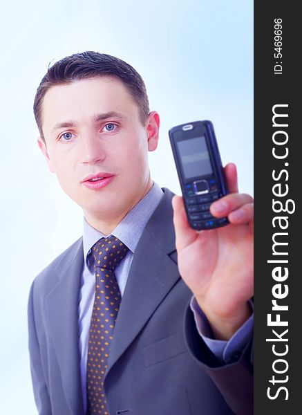 Young businessman showing mobile phone. Young businessman showing mobile phone