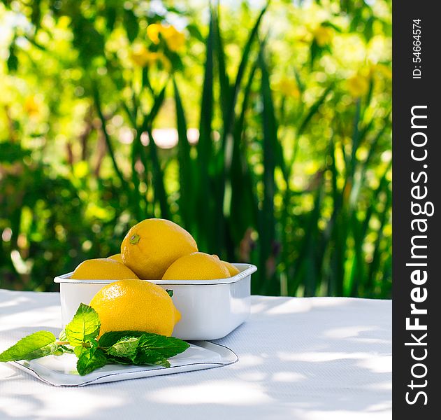 Fresh lemons on the table in the open air. Selective focus.